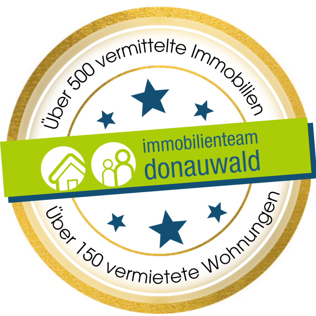 Ein Abzeichen mit der Aufschrift Immobilienmakler Team Donauwald.